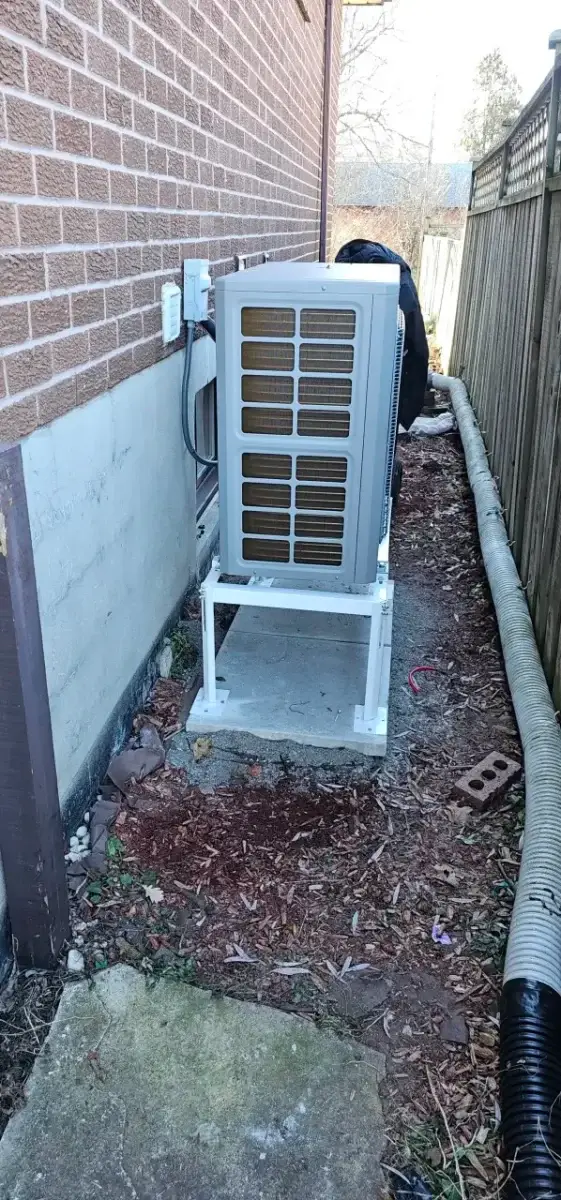 Heat pump outdoor unit on a wall stand, installed by Aurora Star Tech in Aurora